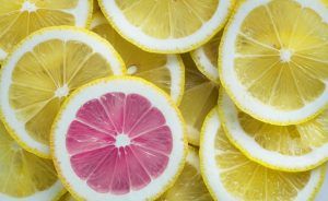 Image of single pink lemon amongst normal lemon slices
